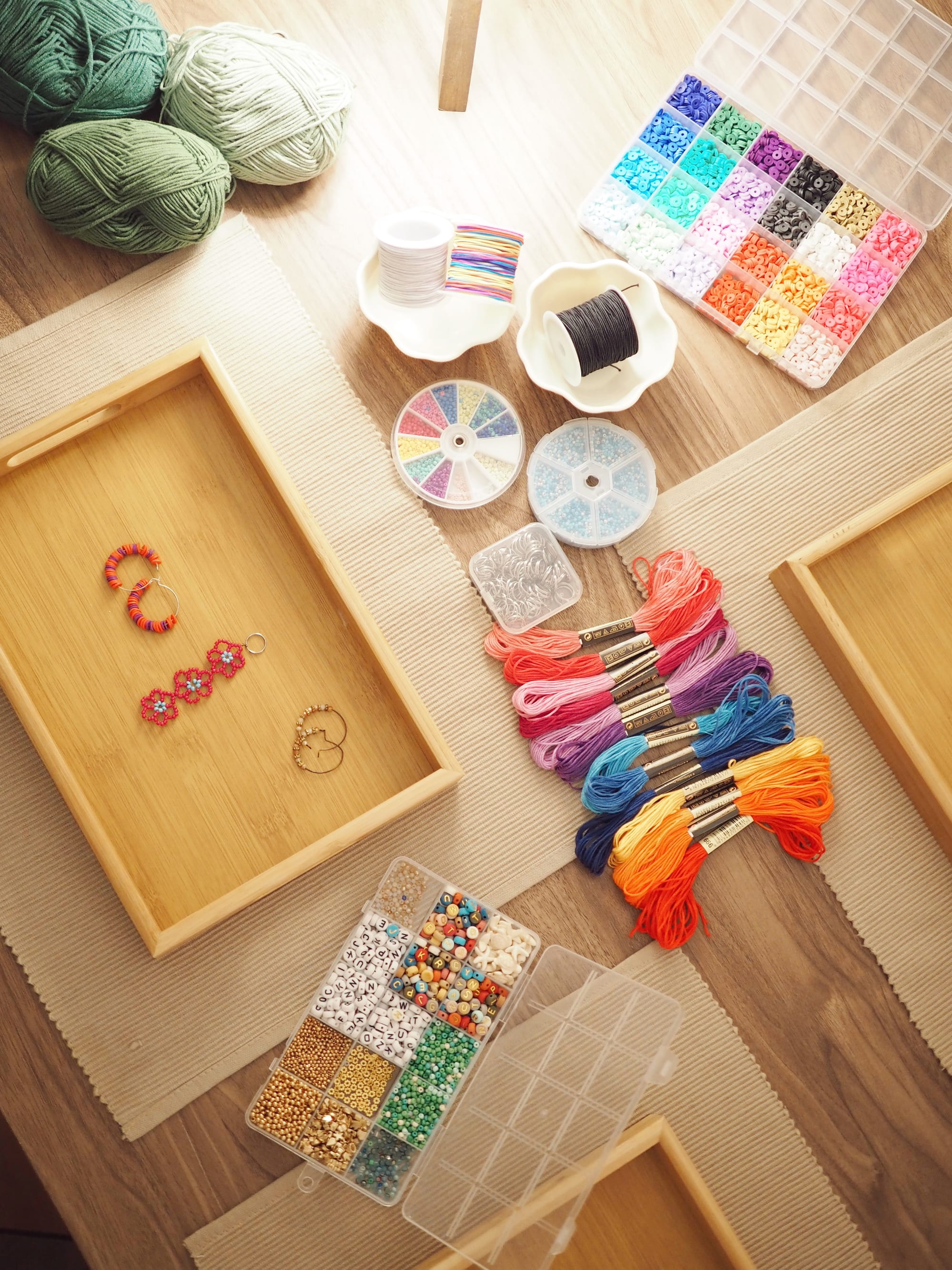Overhead tray of beads, coloured embroidery threads and wooden frames